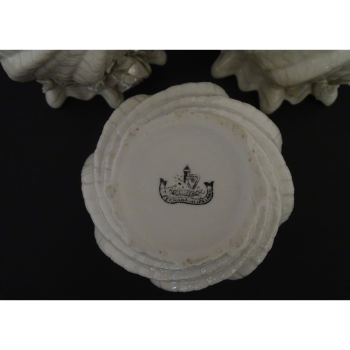 80 - Three small Belleek Neptune vases / jardinieres with applied flower and foliage decoration. Each bea... 