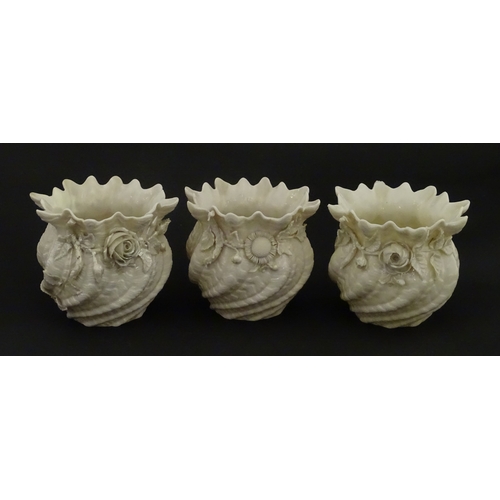 80 - Three small Belleek Neptune vases / jardinieres with applied flower and foliage decoration. Each bea... 