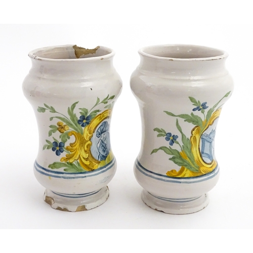 90 - A pair of Italian maiolica albarelli / chemist / drug jars of waisted form, decorated with a portrai... 
