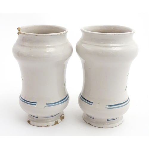 90 - A pair of Italian maiolica albarelli / chemist / drug jars of waisted form, decorated with a portrai... 