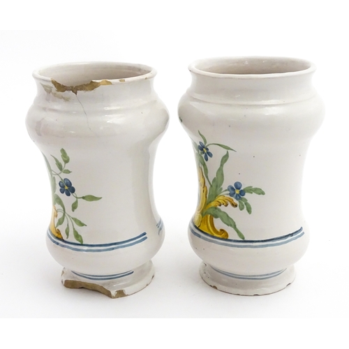 90 - A pair of Italian maiolica albarelli / chemist / drug jars of waisted form, decorated with a portrai... 
