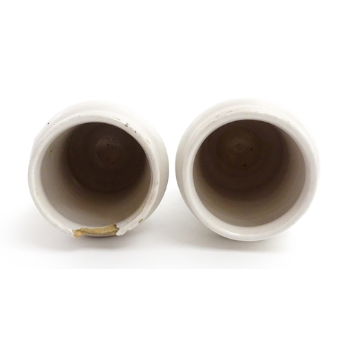 90 - A pair of Italian maiolica albarelli / chemist / drug jars of waisted form, decorated with a portrai... 