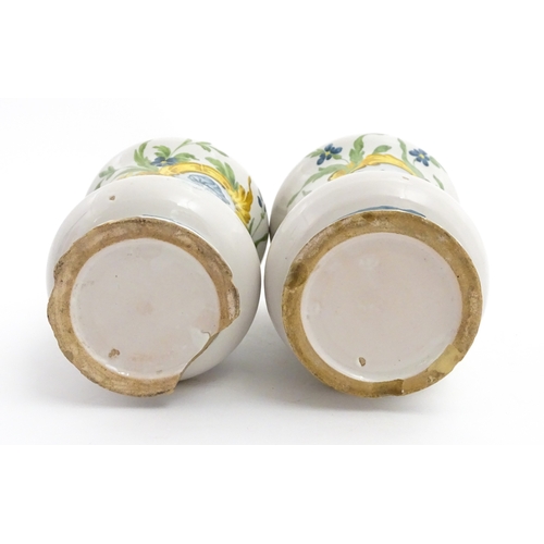 90 - A pair of Italian maiolica albarelli / chemist / drug jars of waisted form, decorated with a portrai... 