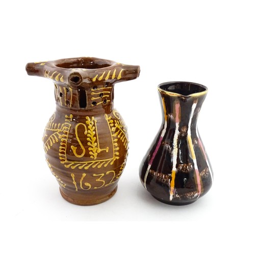 191 - An earthenware puzzle jug with slipware decoration having a pierced neck, decorated with the initial... 