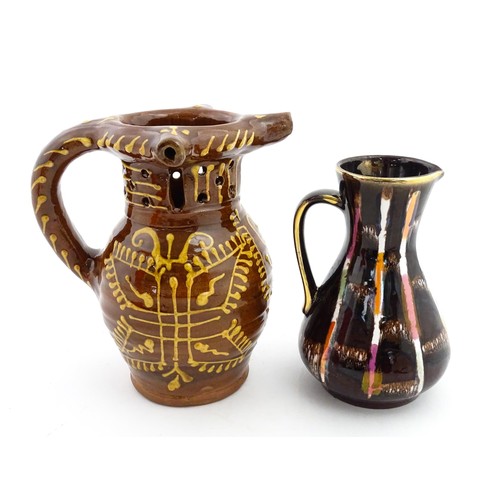 191 - An earthenware puzzle jug with slipware decoration having a pierced neck, decorated with the initial... 