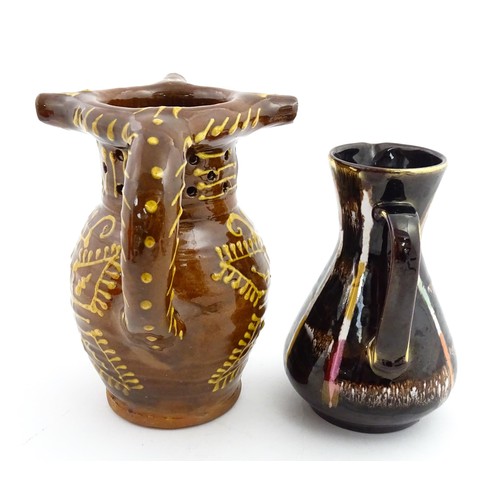 191 - An earthenware puzzle jug with slipware decoration having a pierced neck, decorated with the initial... 