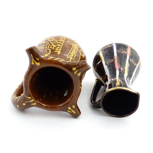 191 - An earthenware puzzle jug with slipware decoration having a pierced neck, decorated with the initial... 