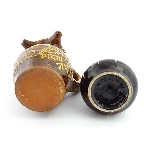 191 - An earthenware puzzle jug with slipware decoration having a pierced neck, decorated with the initial... 