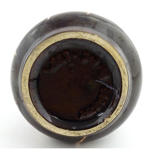 191 - An earthenware puzzle jug with slipware decoration having a pierced neck, decorated with the initial... 