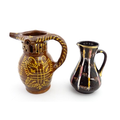 191 - An earthenware puzzle jug with slipware decoration having a pierced neck, decorated with the initial... 