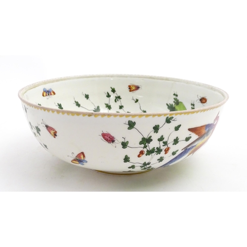 207 - An English bowl with hand painted decoration depicting exotic birds, insects and foliage. In the Che... 