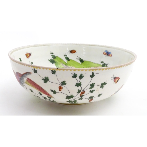 207 - An English bowl with hand painted decoration depicting exotic birds, insects and foliage. In the Che... 