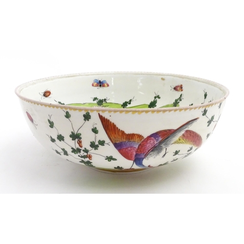 207 - An English bowl with hand painted decoration depicting exotic birds, insects and foliage. In the Che... 