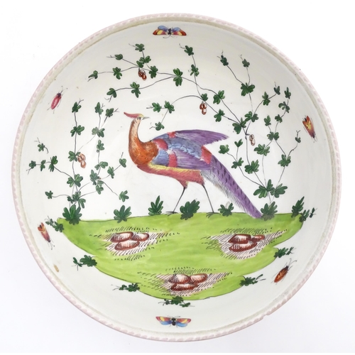 207 - An English bowl with hand painted decoration depicting exotic birds, insects and foliage. In the Che... 