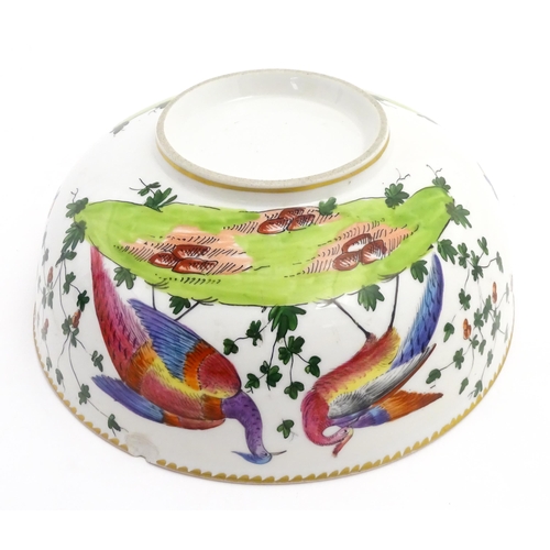 207 - An English bowl with hand painted decoration depicting exotic birds, insects and foliage. In the Che... 