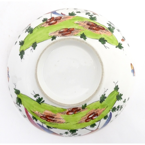 207 - An English bowl with hand painted decoration depicting exotic birds, insects and foliage. In the Che... 