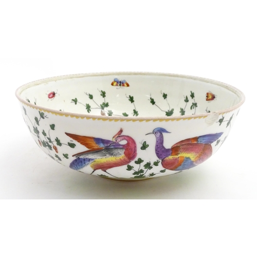 207 - An English bowl with hand painted decoration depicting exotic birds, insects and foliage. In the Che... 