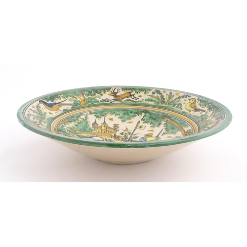 211 - A Spanish talavera / faience bowl by Pedro de la Cal depicting two knights on horseback and a dog ap... 