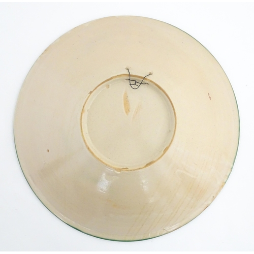 211 - A Spanish talavera / faience bowl by Pedro de la Cal depicting two knights on horseback and a dog ap... 