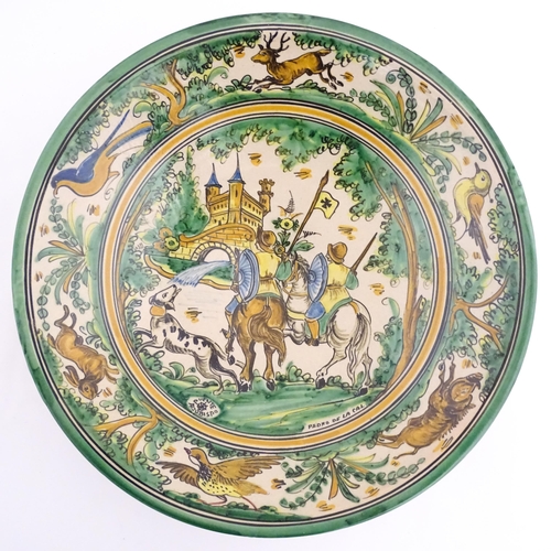 211 - A Spanish talavera / faience bowl by Pedro de la Cal depicting two knights on horseback and a dog ap... 