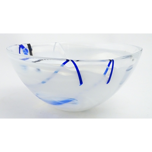 320 - A large Kosta Boda art glass bowl with blue and black detail. Approx. 6 1/2