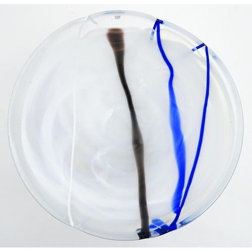 320 - A large Kosta Boda art glass bowl with blue and black detail. Approx. 6 1/2