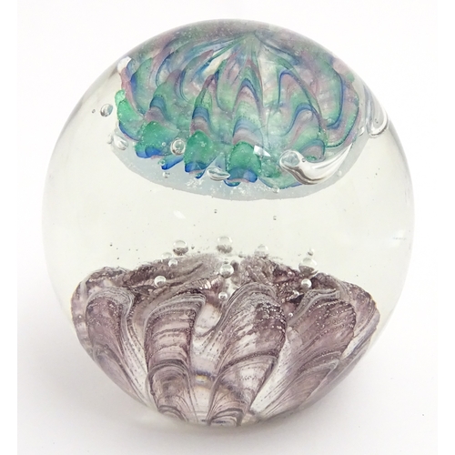 321 - A large art glass paperweight with purple, blue and green detail. Approx. 5