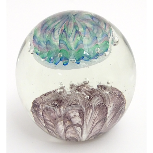 321 - A large art glass paperweight with purple, blue and green detail. Approx. 5