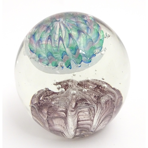 321 - A large art glass paperweight with purple, blue and green detail. Approx. 5