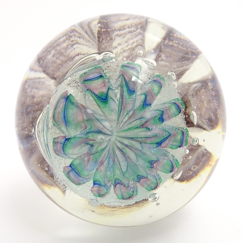321 - A large art glass paperweight with purple, blue and green detail. Approx. 5