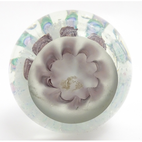 321 - A large art glass paperweight with purple, blue and green detail. Approx. 5