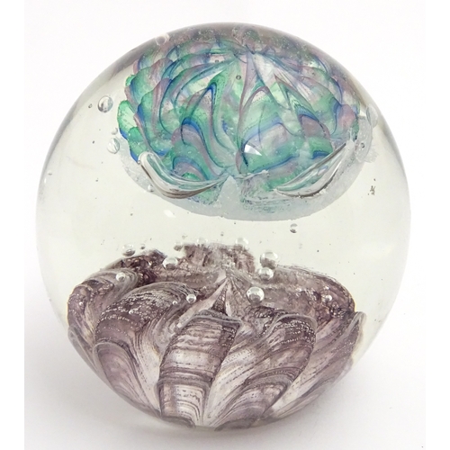 321 - A large art glass paperweight with purple, blue and green detail. Approx. 5