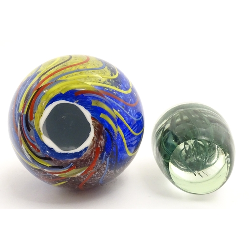 323 - An art glass paperweight of egg form with abstract coloured swirl detail. Together with a smaller gl... 