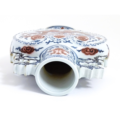 10 - A Chinese red, blue and white vase with scrolling twin handles, decorated with a dragon amongst styl... 