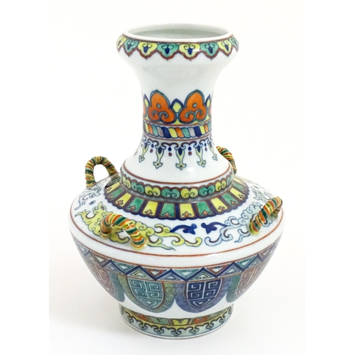 14 - A Chinese Doucai vase with four loop handles, decorated with stylised dragons and banded borders. Ch... 