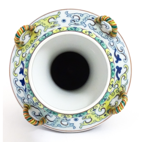 14 - A Chinese Doucai vase with four loop handles, decorated with stylised dragons and banded borders. Ch... 