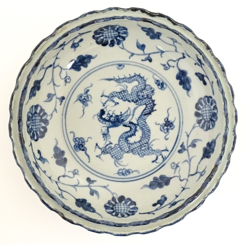 31 - Two Chinese blue and white dishes, to include on with dragon decoration to centre bordered by flower... 