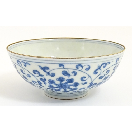 33 - Two small Chinese blue and white bowls with scrolling floral decoration. Both with character marks u... 