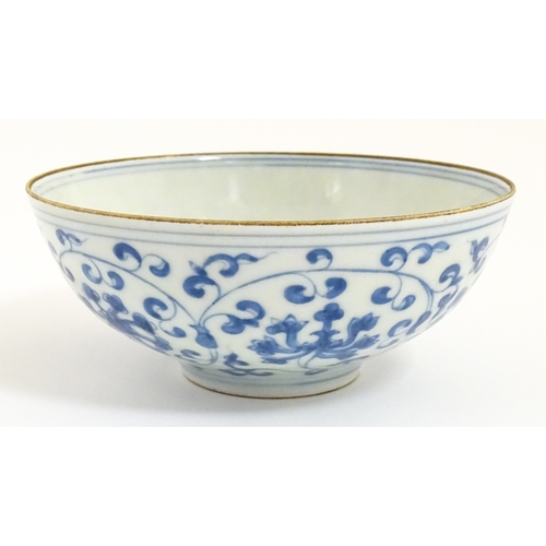 33 - Two small Chinese blue and white bowls with scrolling floral decoration. Both with character marks u... 