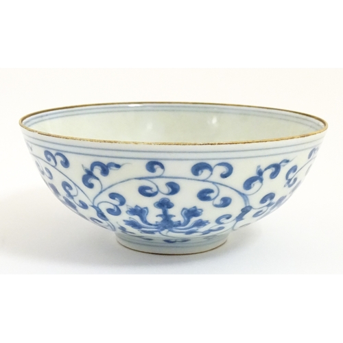 33 - Two small Chinese blue and white bowls with scrolling floral decoration. Both with character marks u... 