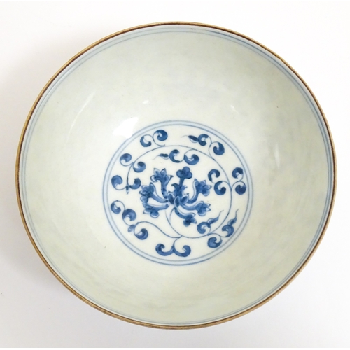 33 - Two small Chinese blue and white bowls with scrolling floral decoration. Both with character marks u... 