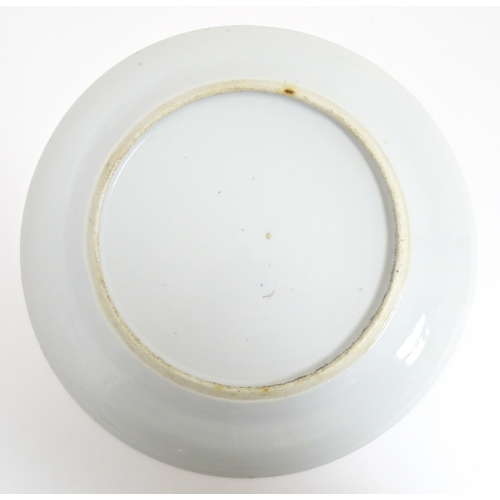 34 - A Chinese export blue and white plate decorated with a river landscape with figures, pagodas, etc. T... 