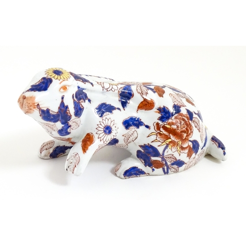 34 - A Chinese export blue and white plate decorated with a river landscape with figures, pagodas, etc. T... 