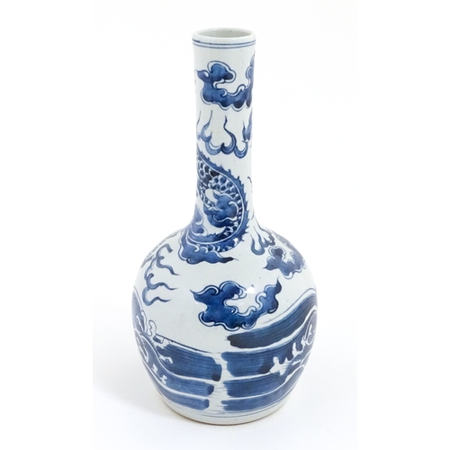 39 - A Chinese blue and white vase decorated with a dragon above waves with fish. Character marks under. ... 