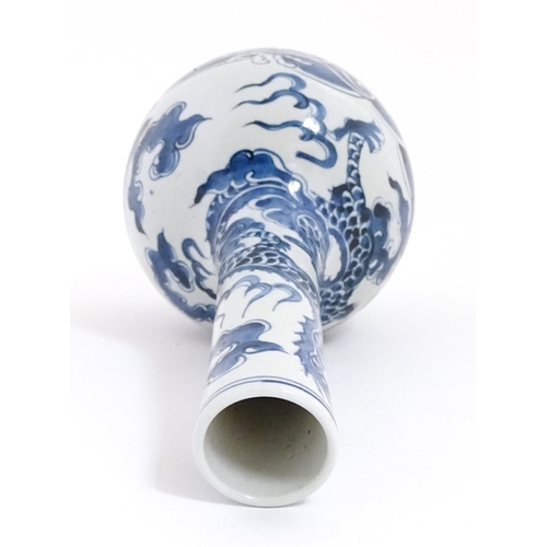 39 - A Chinese blue and white vase decorated with a dragon above waves with fish. Character marks under. ... 