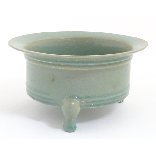 52 - A Chinese celadon planter raised on three feet. approx. 7 1/2