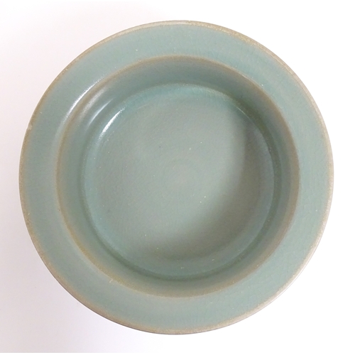 52 - A Chinese celadon planter raised on three feet. approx. 7 1/2