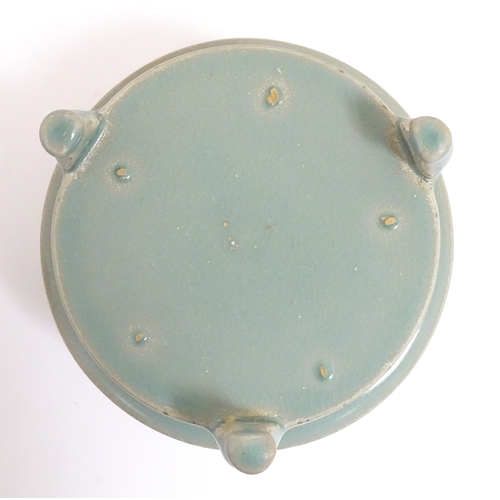 52 - A Chinese celadon planter raised on three feet. approx. 7 1/2