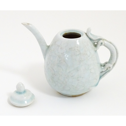 7 - A small Chinese teapot with scrolling detail. Approx. 4 1/2