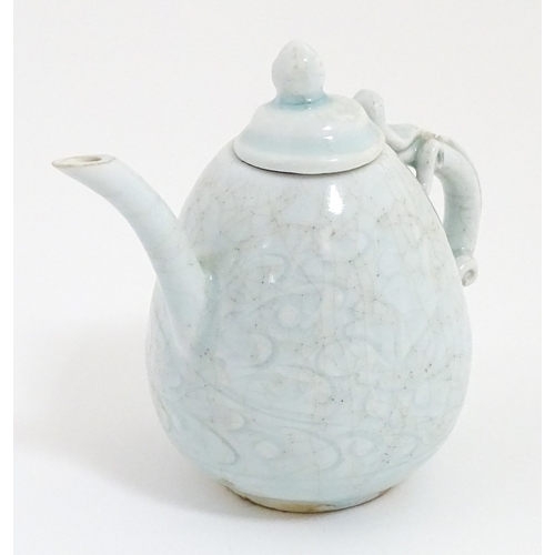 7 - A small Chinese teapot with scrolling detail. Approx. 4 1/2
